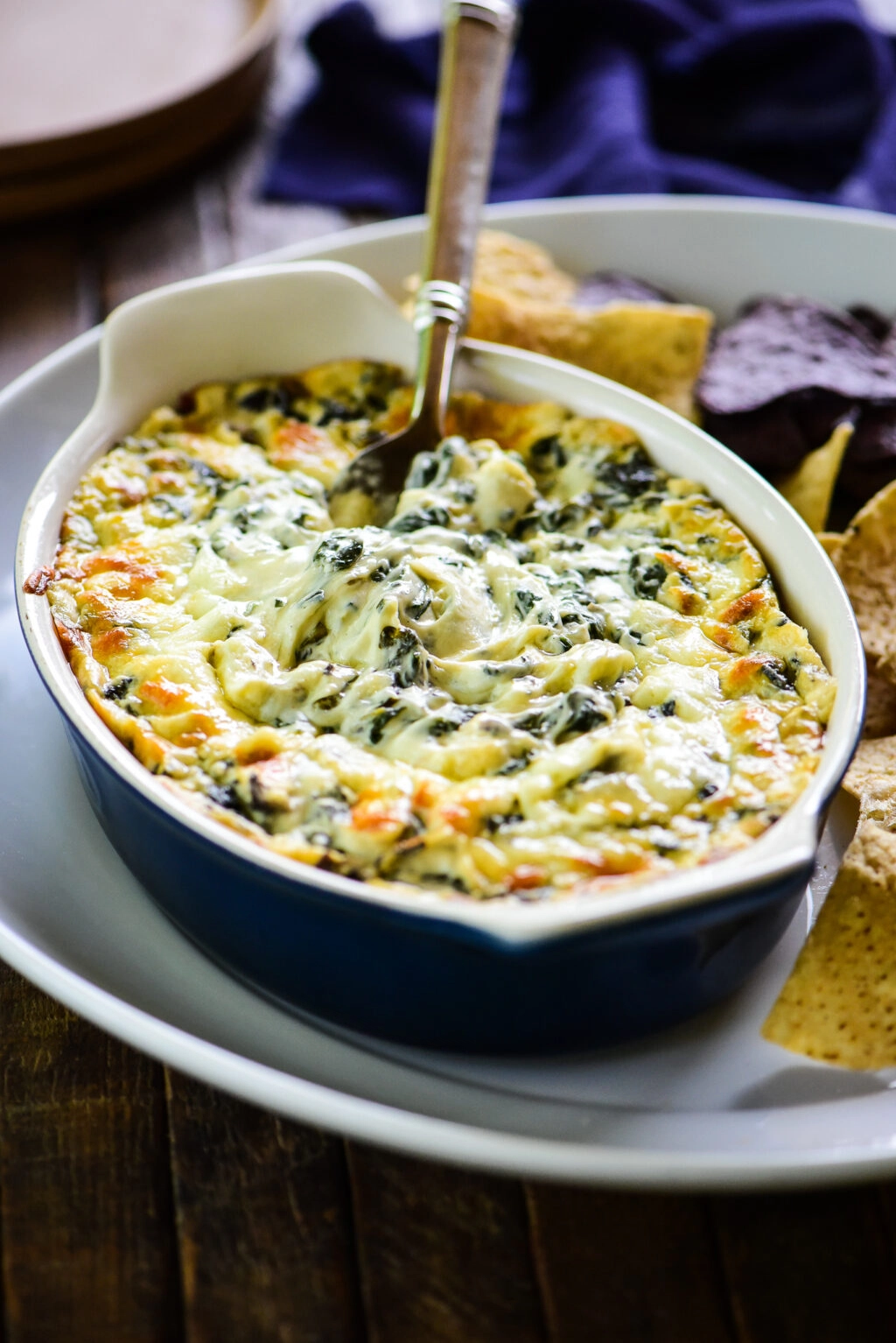 cheesy spinach dip with a serving spoon
