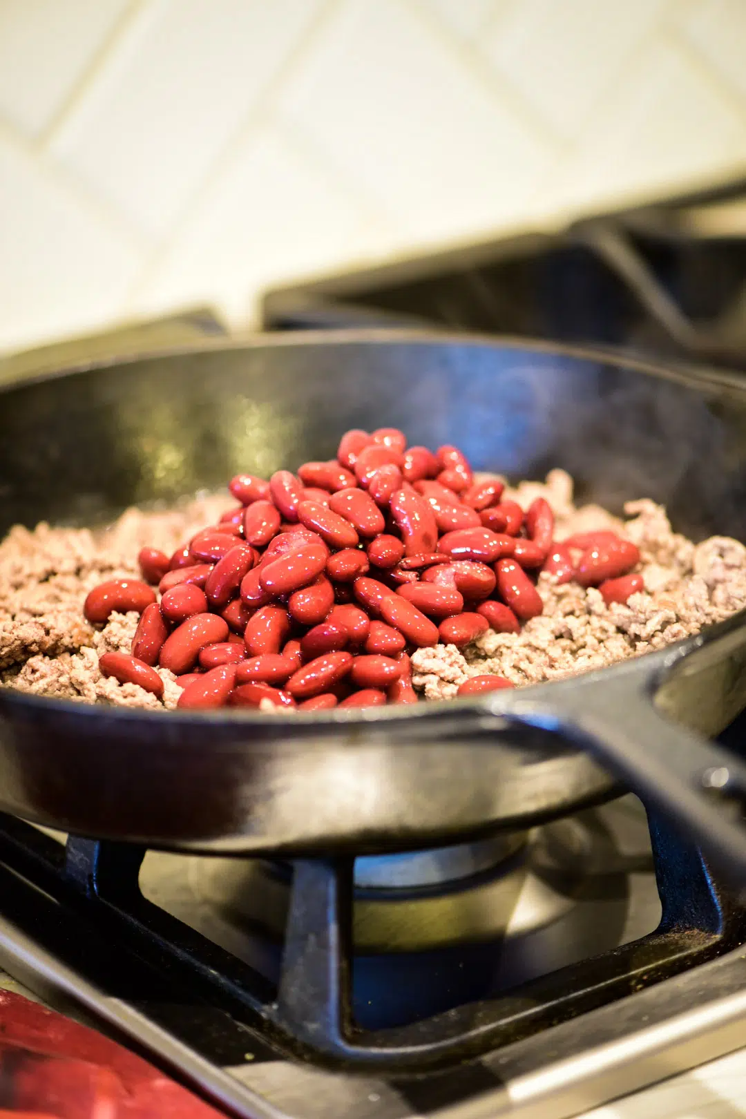 Adding beans to ground beef mixture