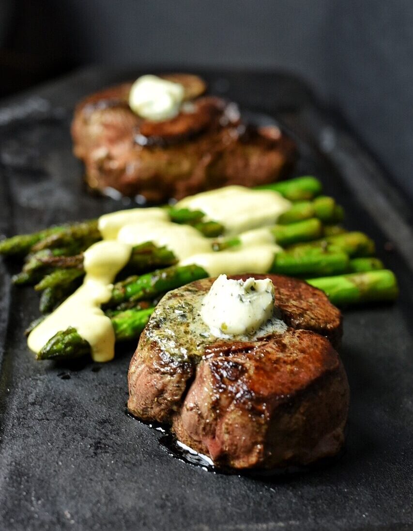 Two steakhouse Filet Mignon served with asparagus and homemade Hollandaise Sauce