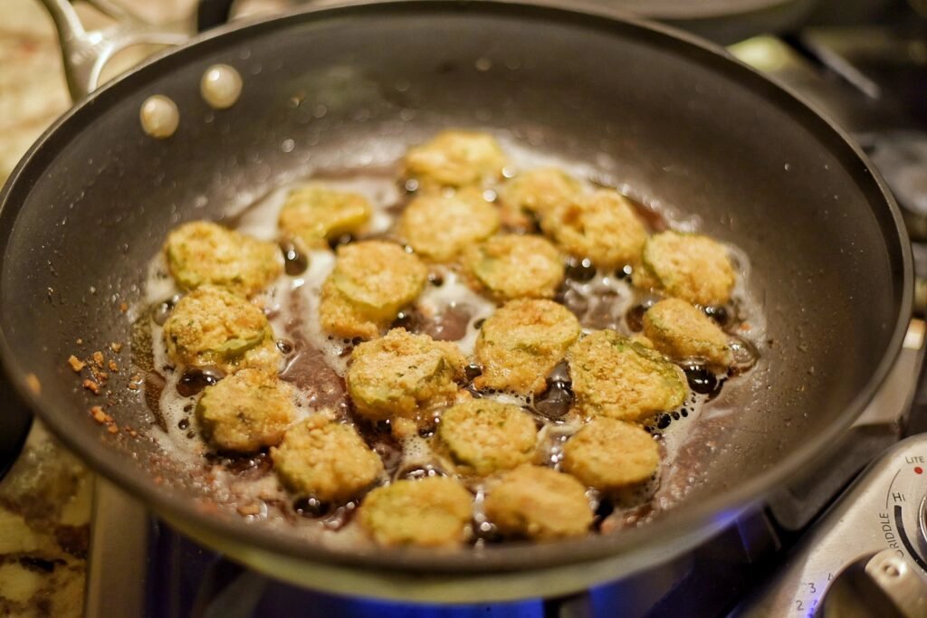 Pickle frying time! Frying the dill pickles in hot oil.