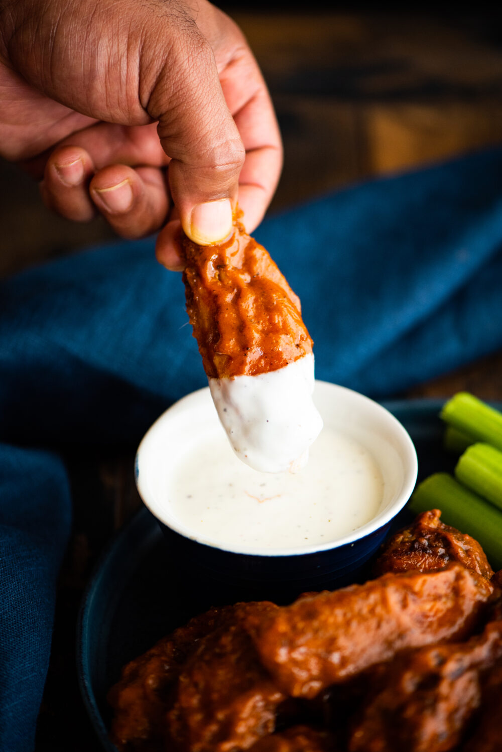 dipping hot wing into ranch sauce