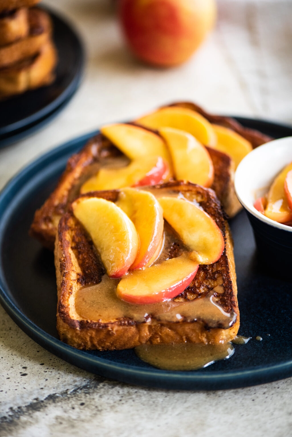 plate of french toast topped with apples