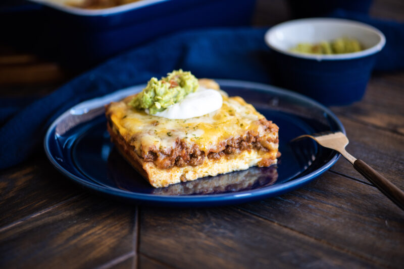 Low-Carb Tex-Mex Casserole topped with sour cream and guacamole