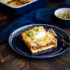 Low-Carb Tex-Mex Casserole topped with sour cream and guacamole