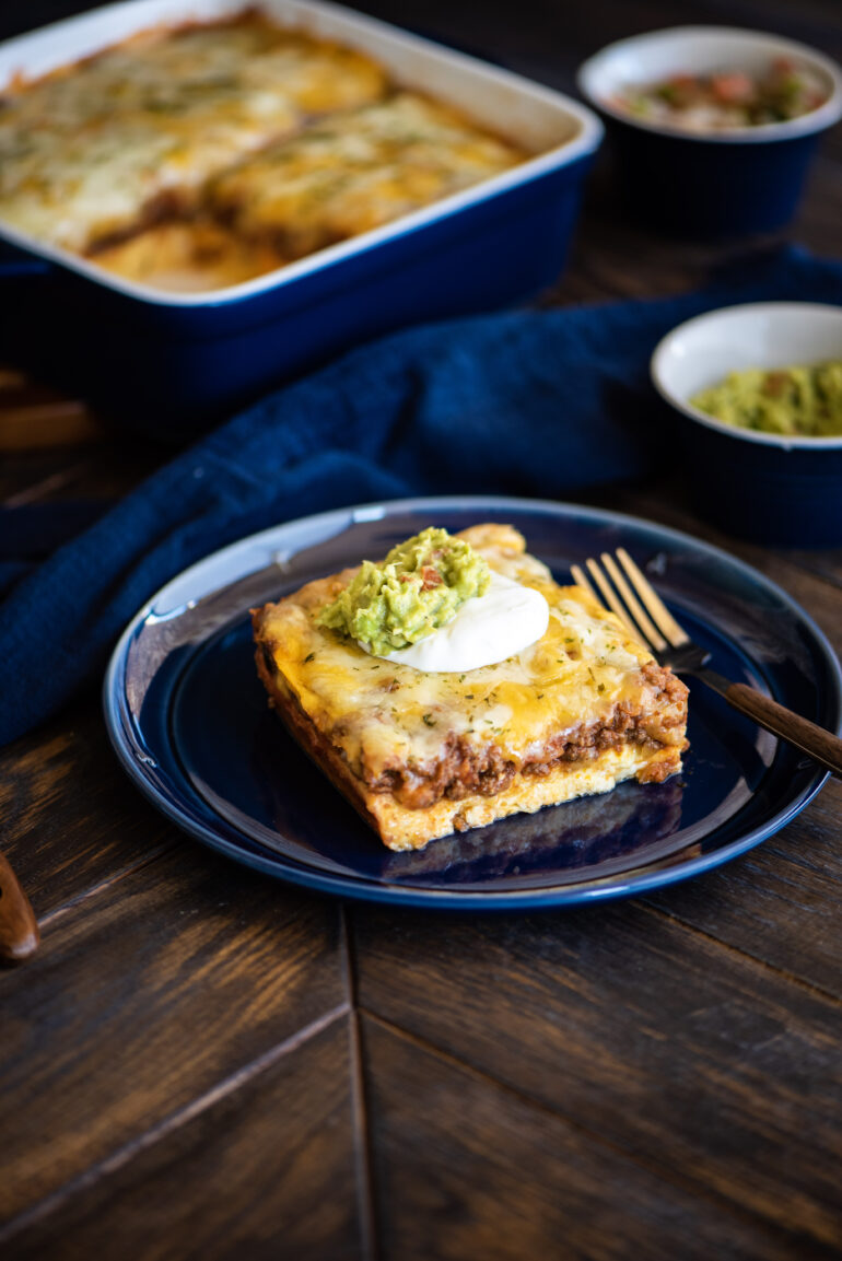 Low-Carb Tex-Mex Casserole topped with sour cream and guacamole