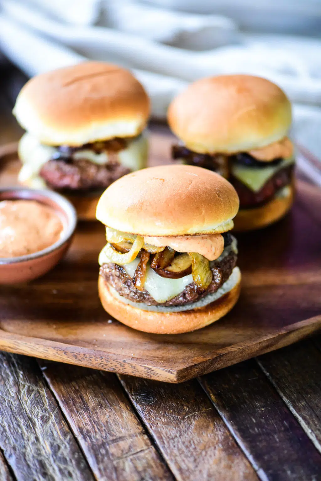 three hamburger sliders with secret sauce