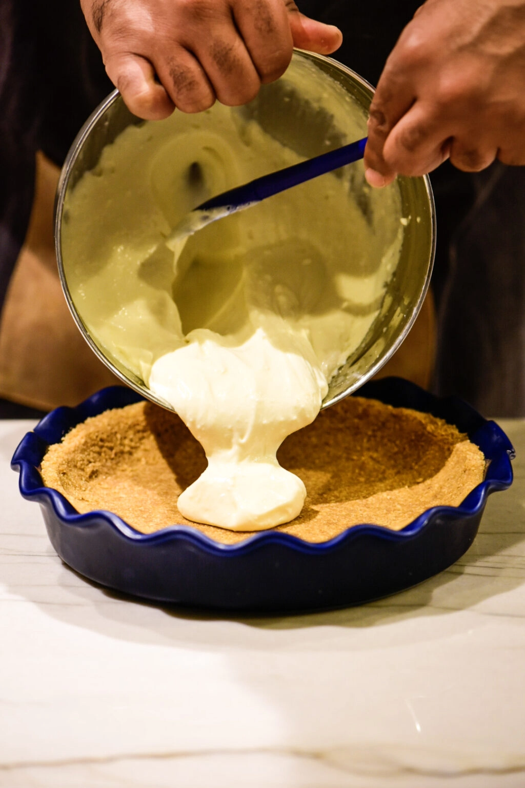 Pouring lemon pie filling into pie dish