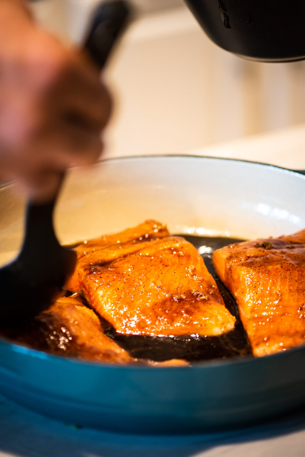 adding honey balsamic glaze to trout before placing in oven
