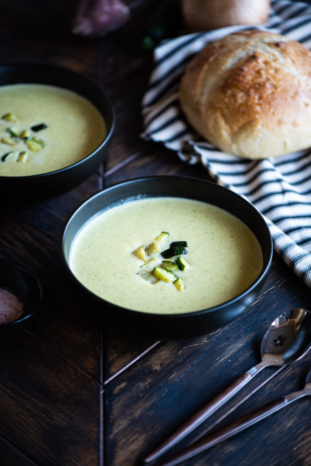 zucchini and sweet potato soup served with a spoon