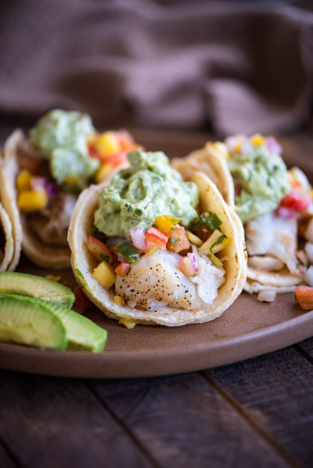 grilled fish taco front facing with avocado cream