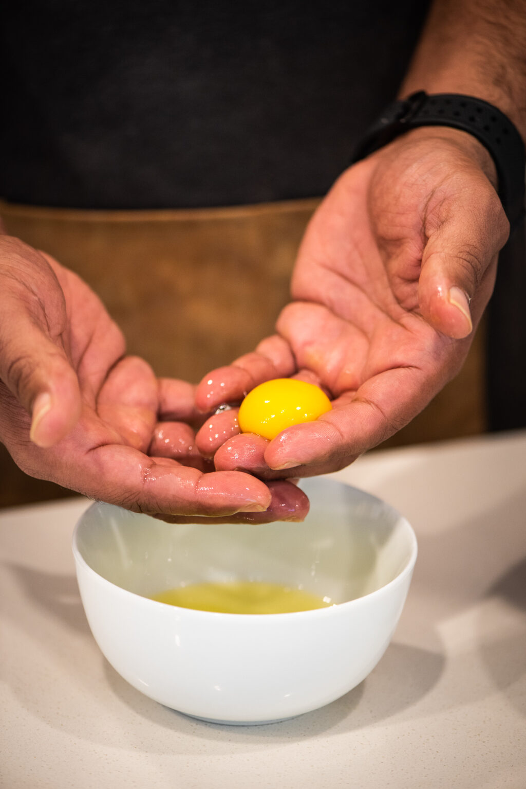 separating egg yolk from egg white to make hollandaise sauce