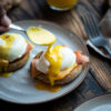 topping eggs benedict with hollandaise sauce