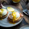 topping eggs benedict with hollandaise sauce