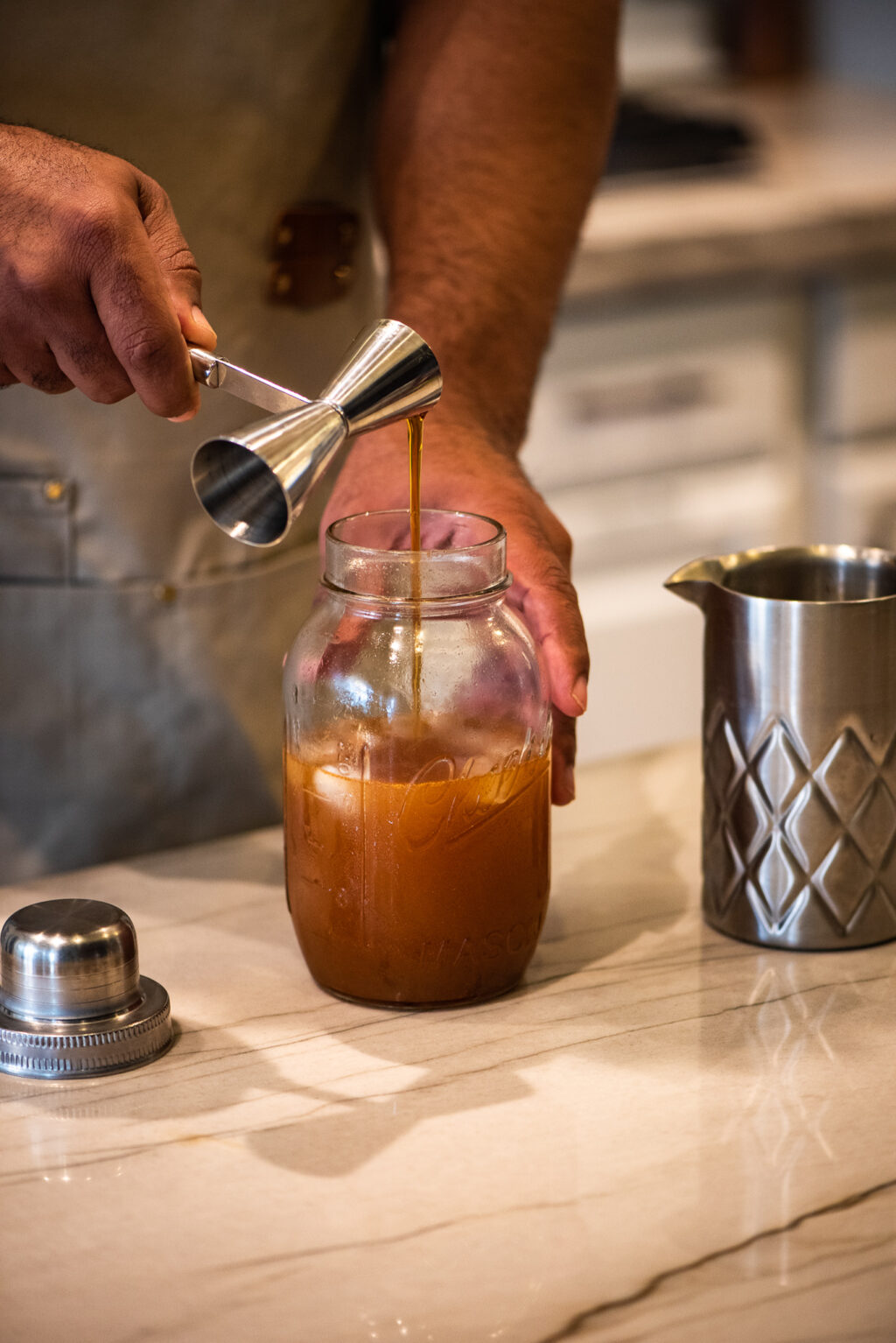 Adding maple syrup to cocktail shaker