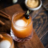 Single Cinnamon Maple Whiskey Sour on wooden board