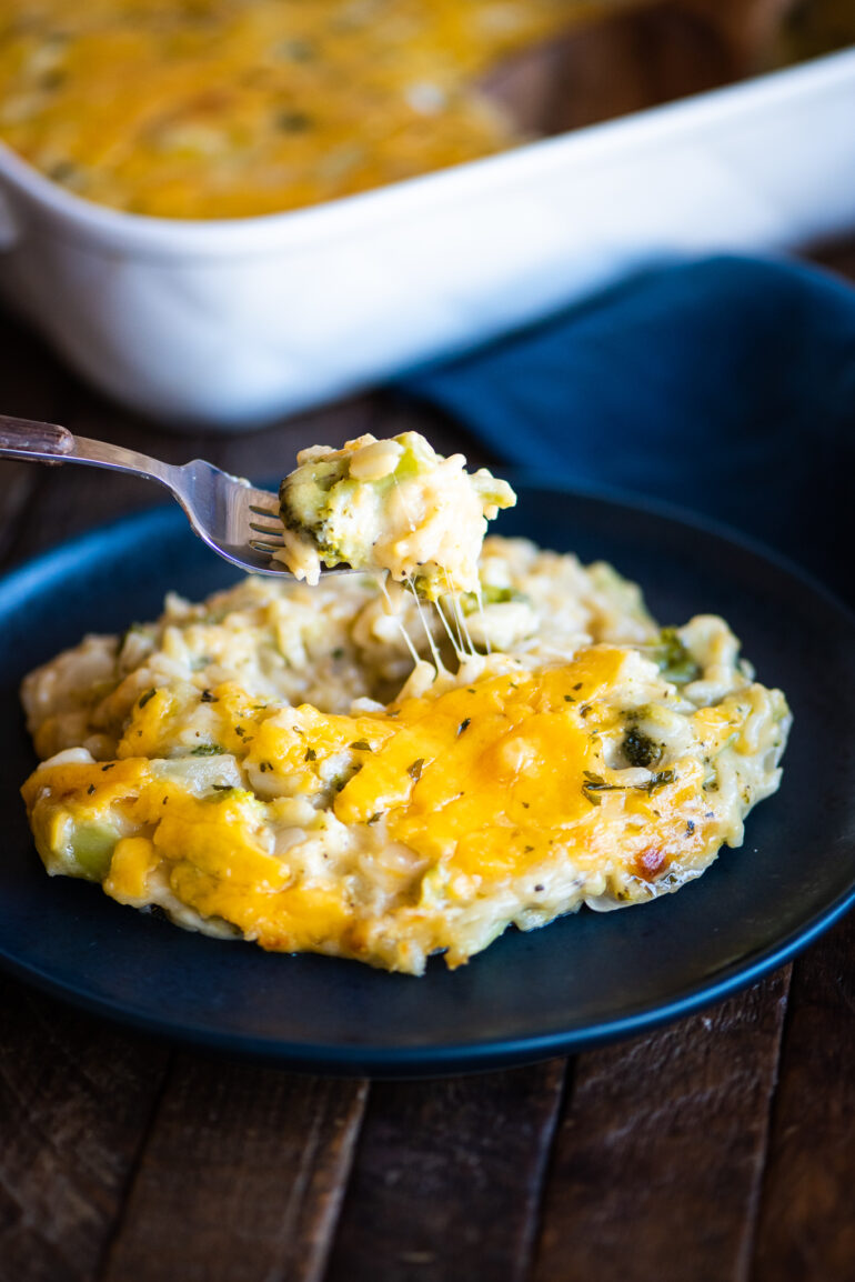 eating broccoli and cheese casserole with a fork
