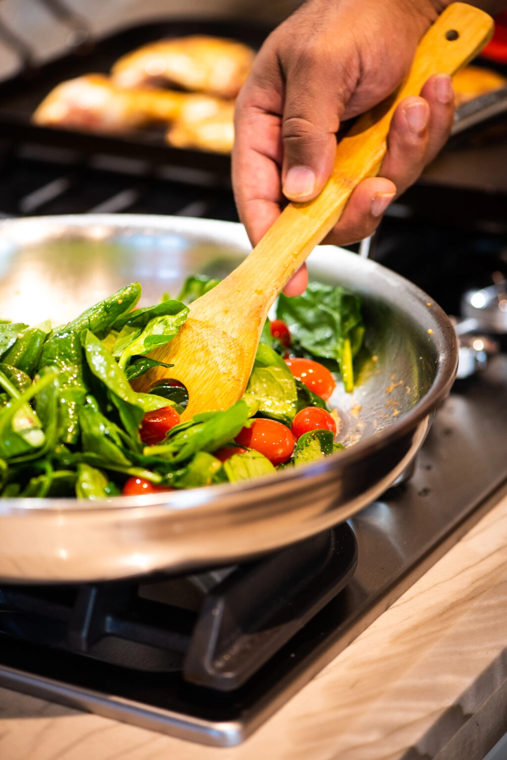 sautéing fresh spinach and tomatoes