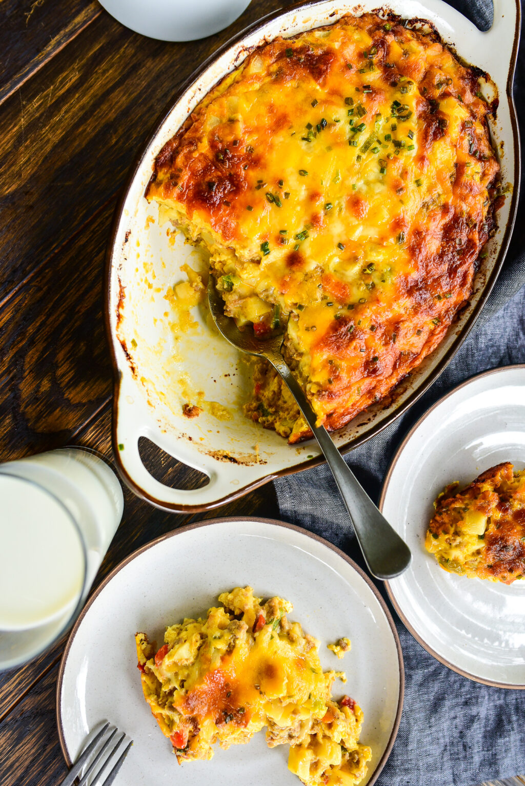 overhead shot of hashbrown casserole with with two serving plates