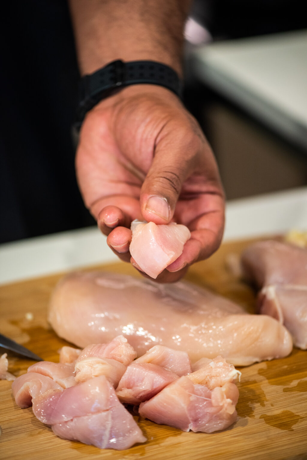 cutting chicken breast into medium-sized chunks
