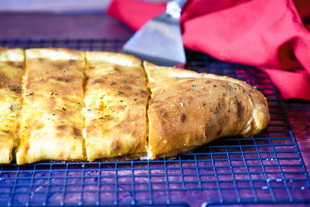 Allowing the Buffalo Chicken Calzone to rest after baking