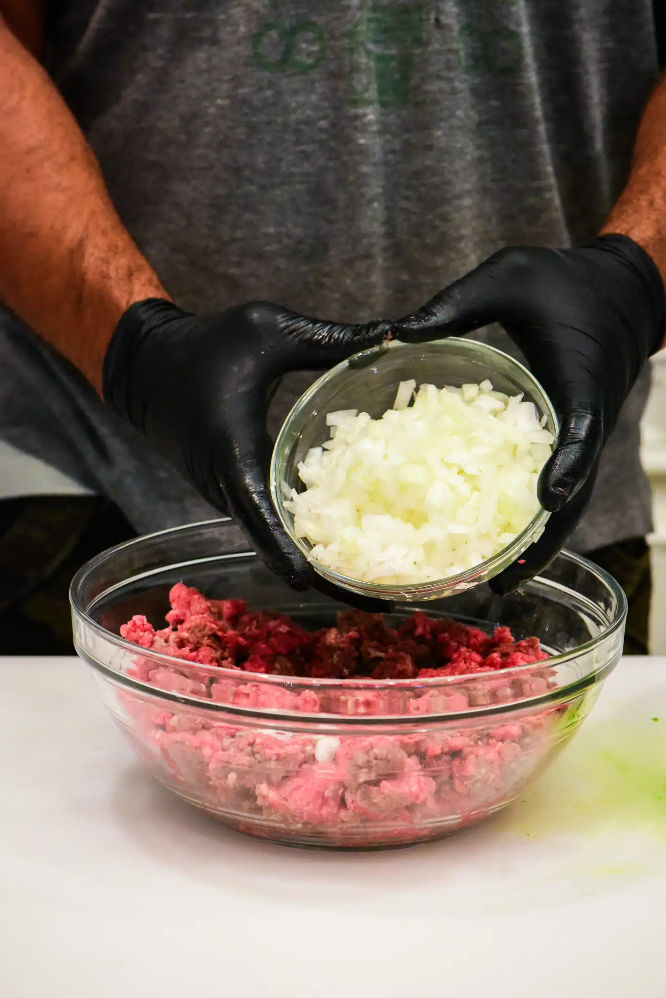 adding white onions to meatloaf mixture