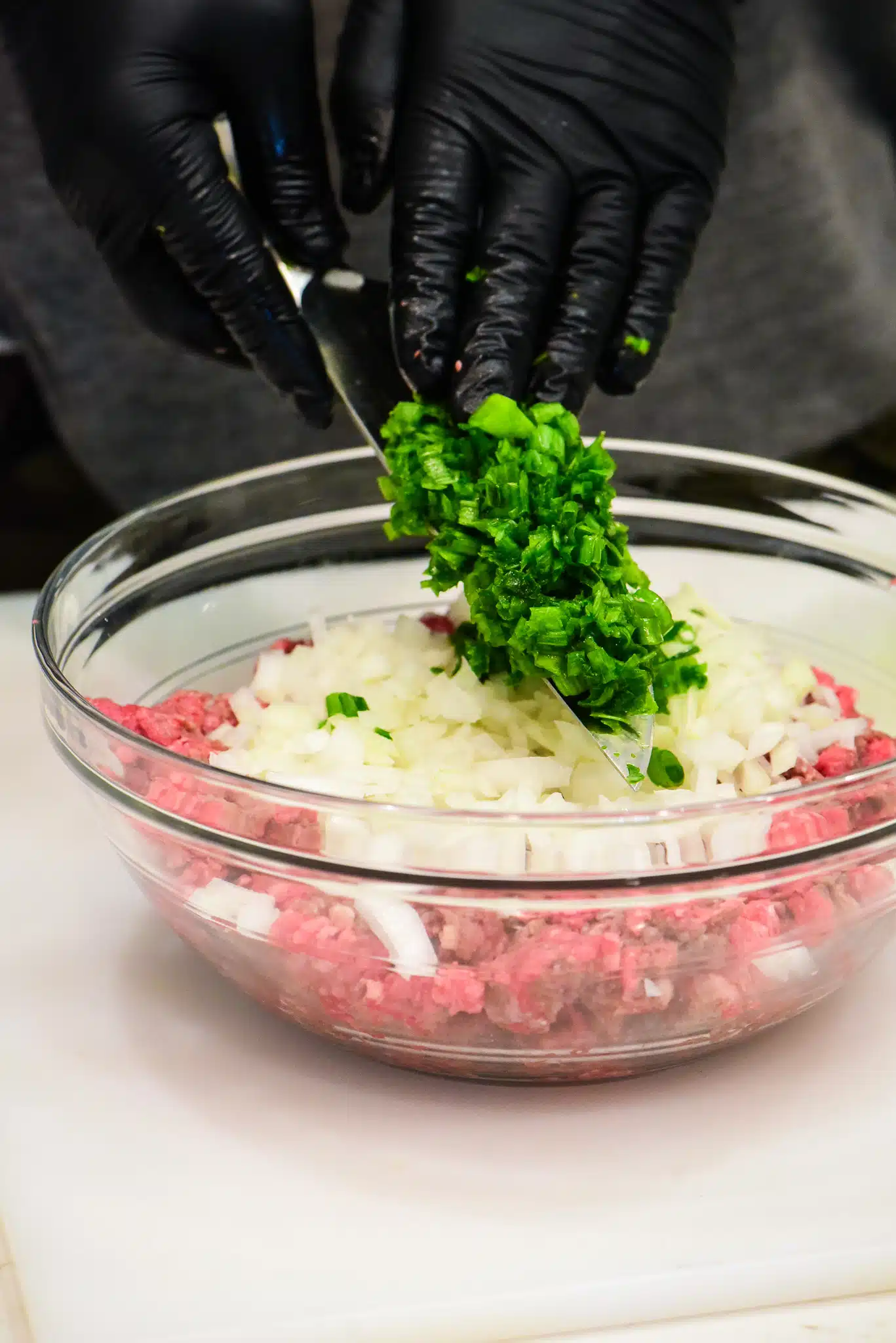 adding green onions to meatloaf mixture