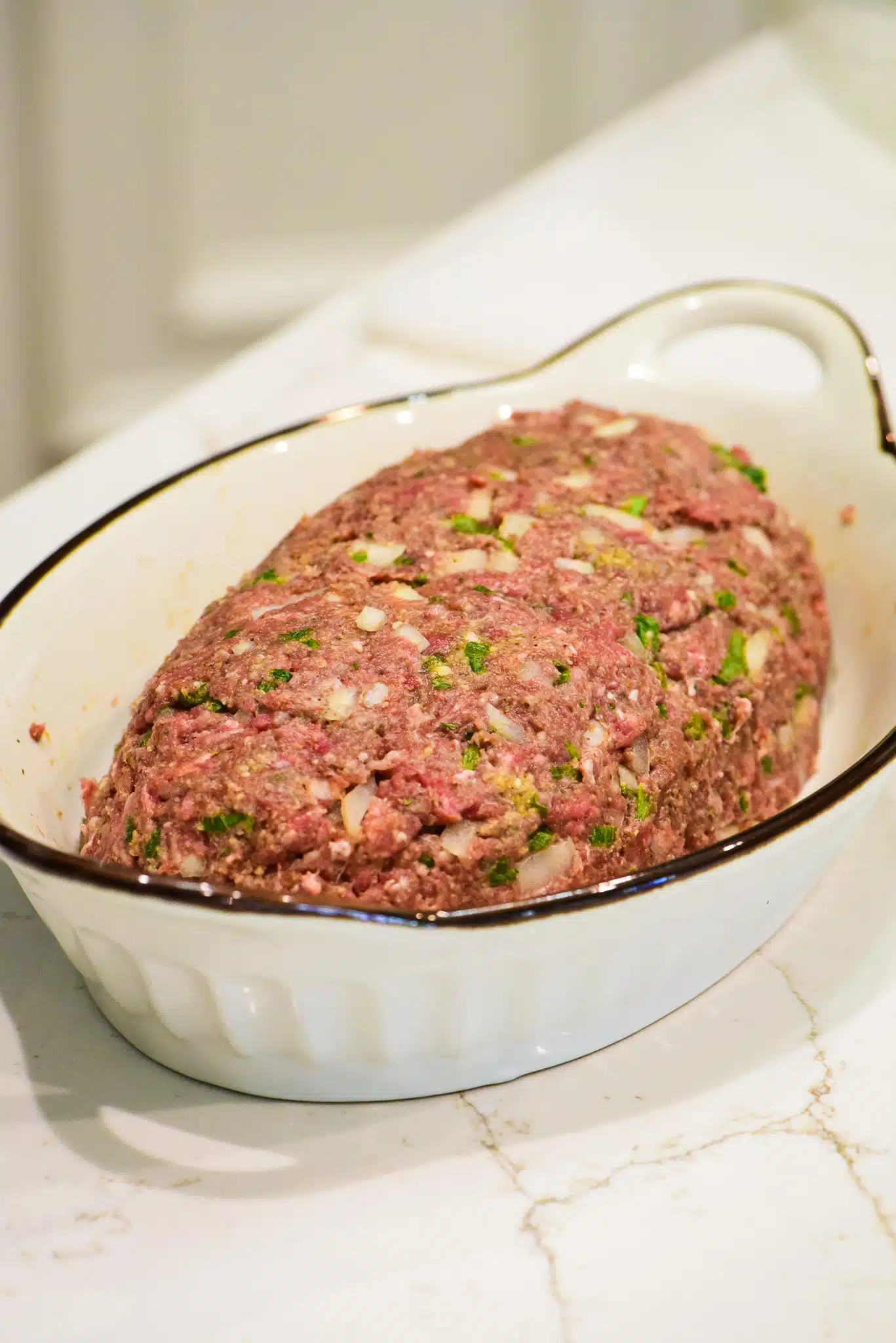 forming meatloaf and placing in casserole dish