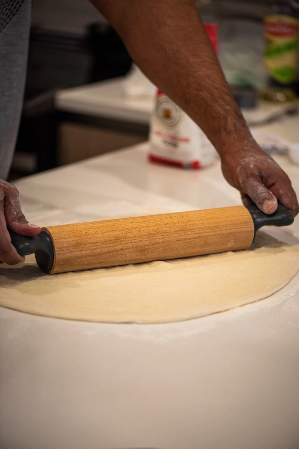 rolling out pizza dough