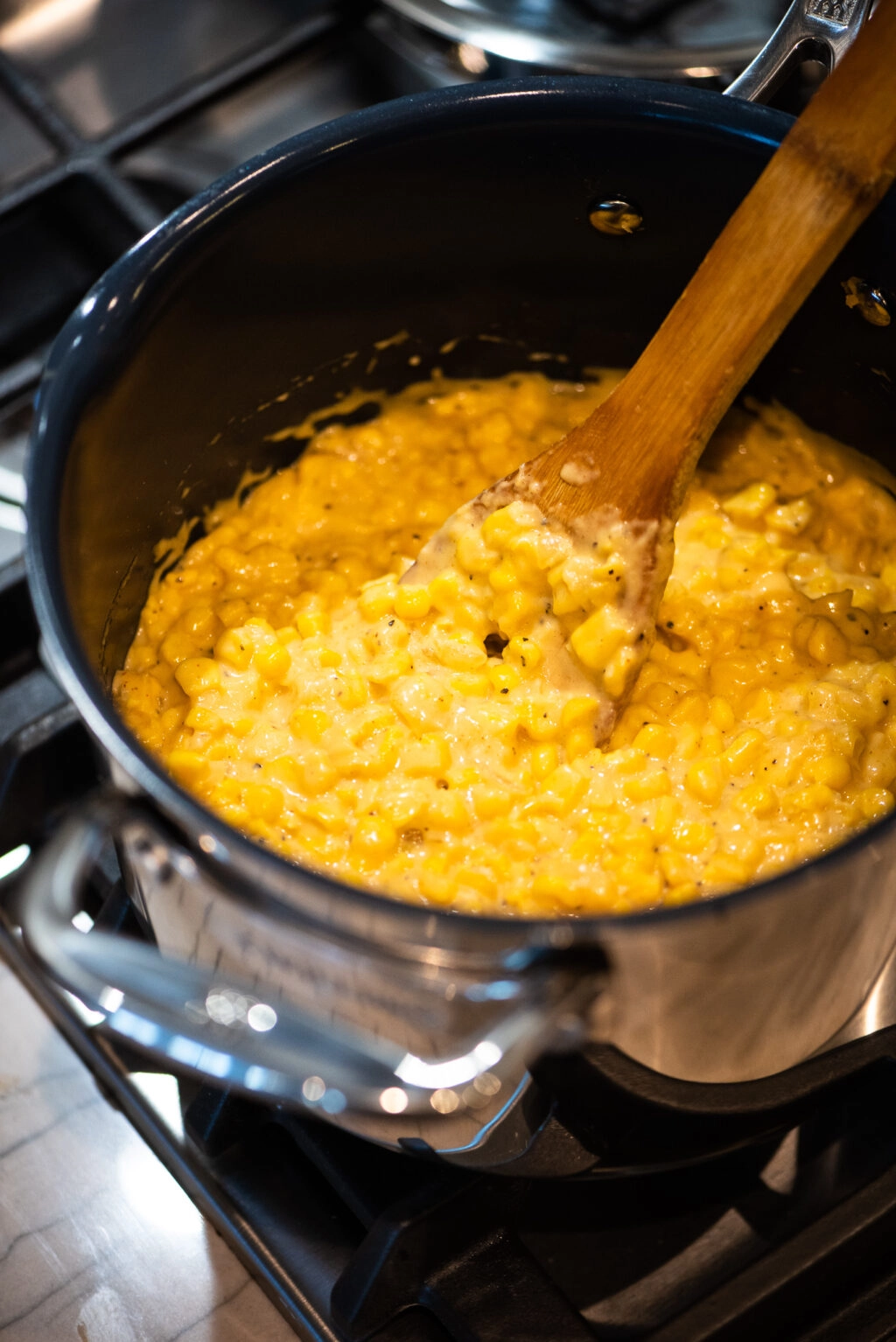 Creamed corn after adding cream, milk, and cheese