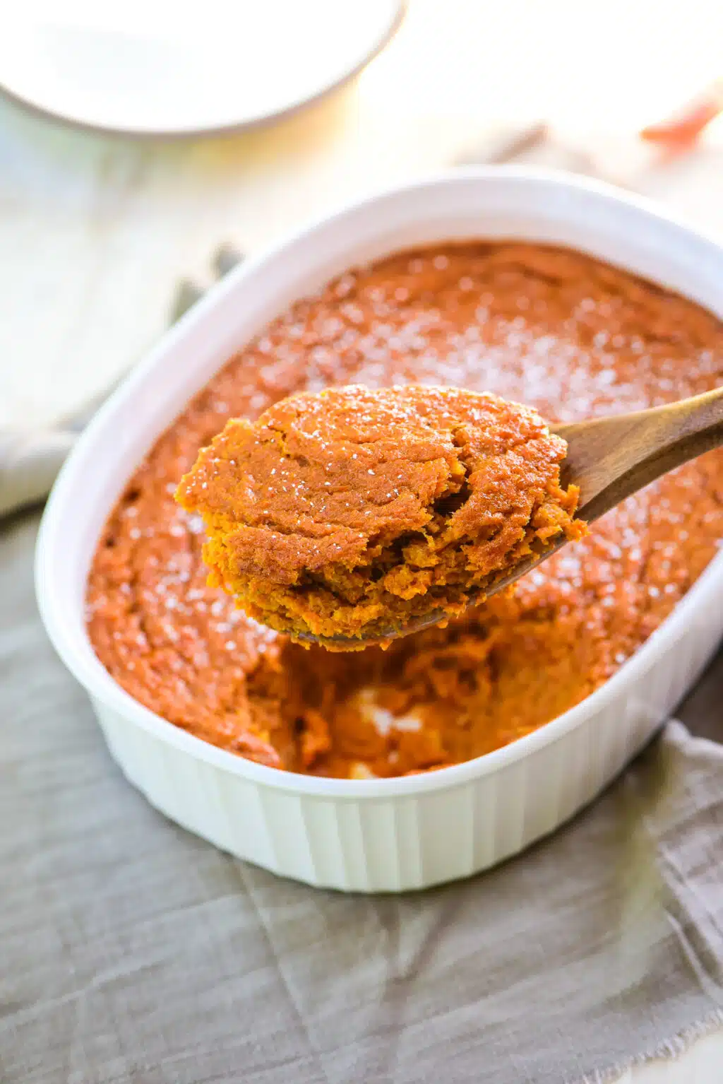 taking a serving out of the carrot souffle casserole dish