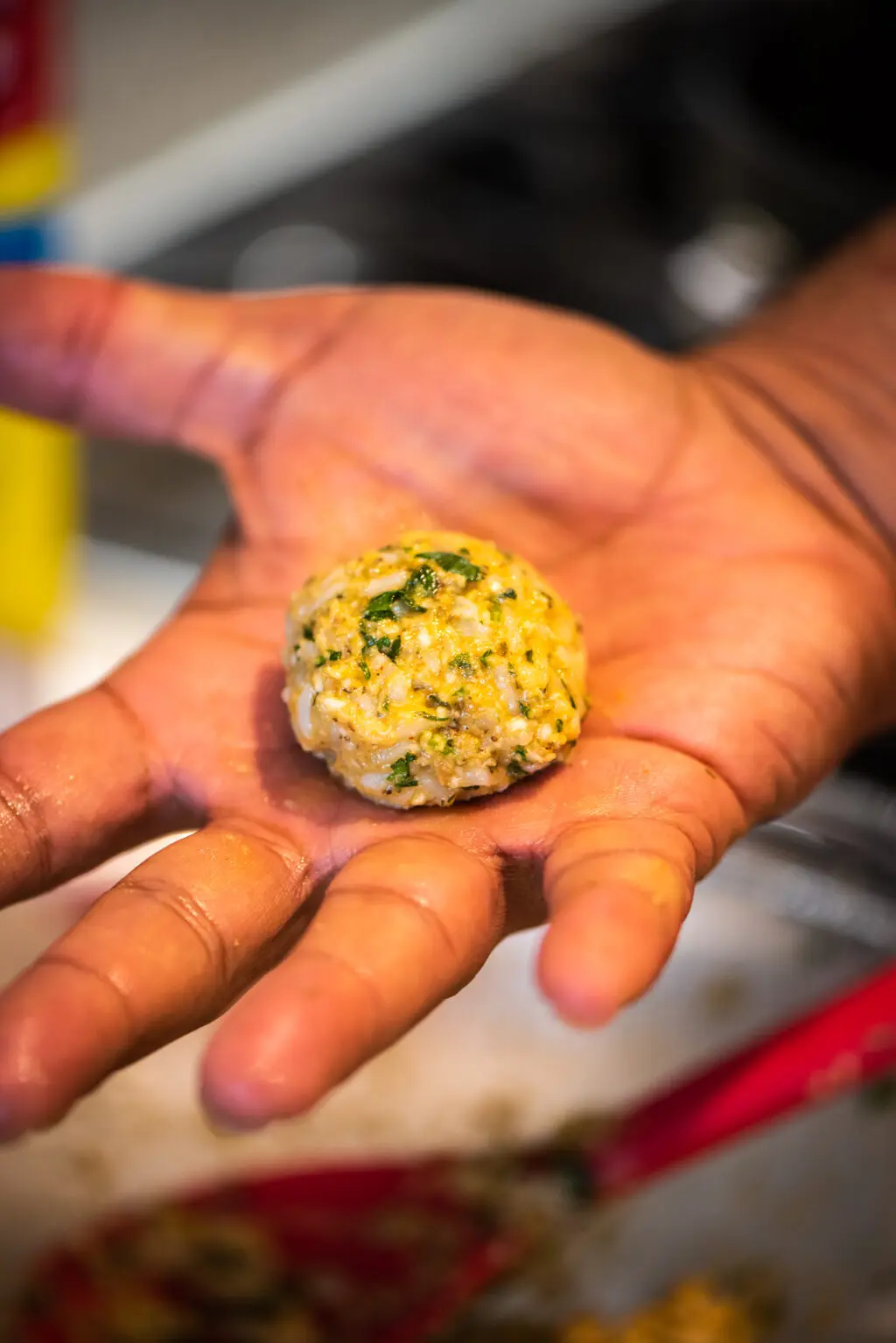 rolling arancini into a small ball