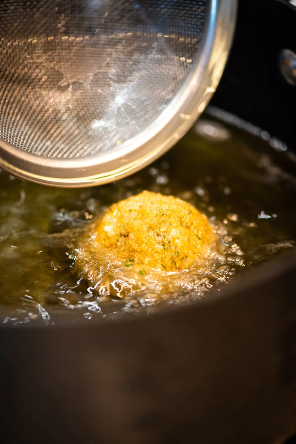 deep drying arancini in skillet