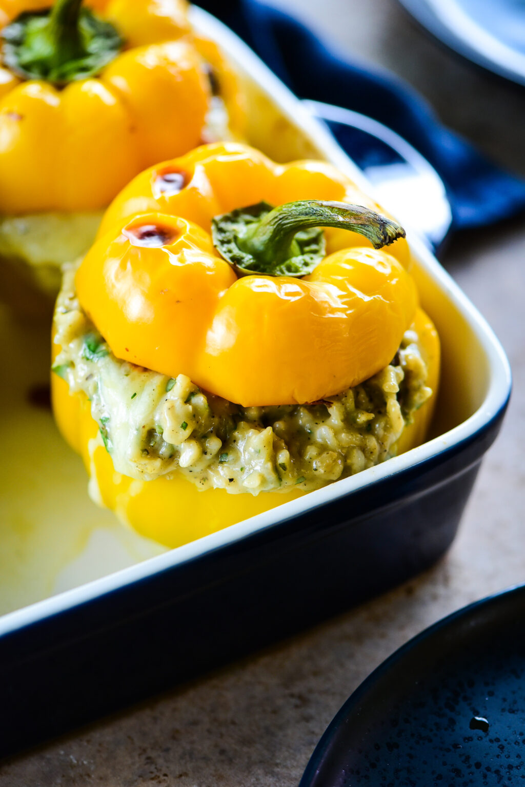 stuffed yellow bell pepper with baked cap on