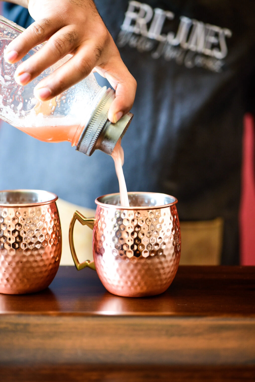 Pouring Watermelon Moscow Mule Cocktail in mule cup