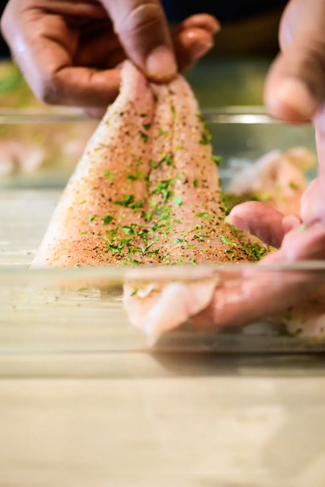 placing flounder in baking dish