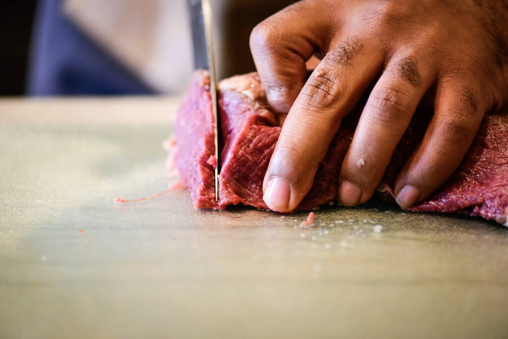 Slicing beef tenderloin into thin slices