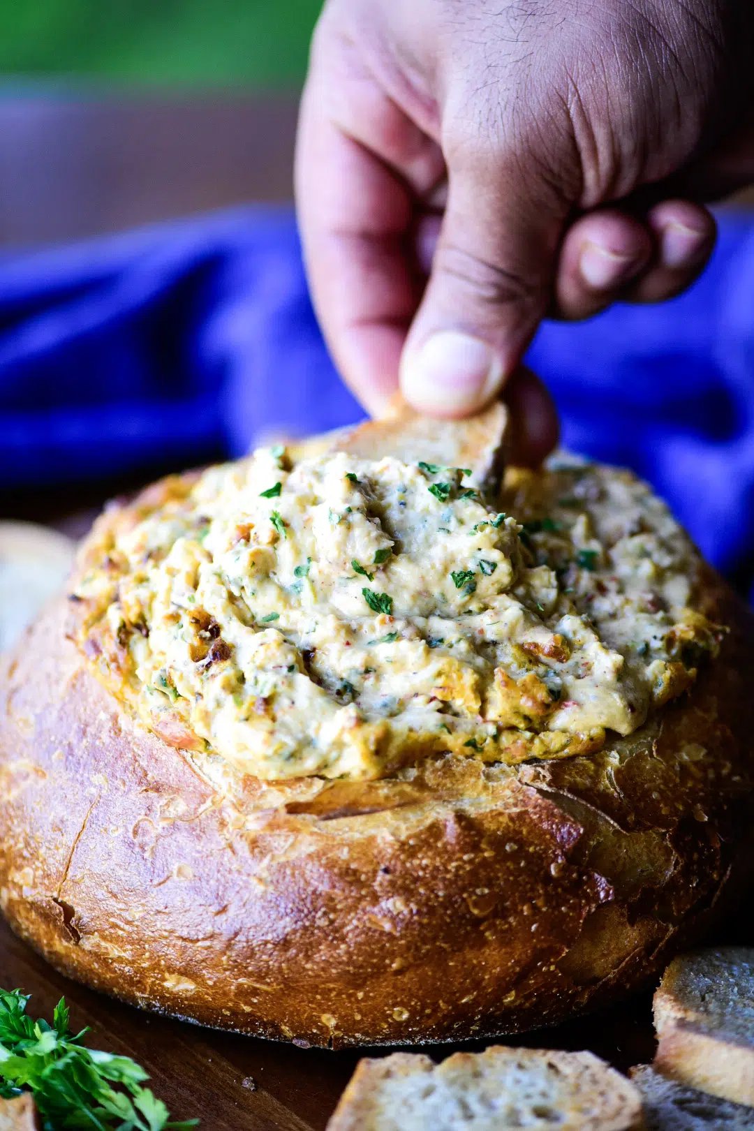 Dipping toasted baguette into hot fish dip