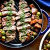 Overhead shot of sliced new york strip loin with chimichurri sauce