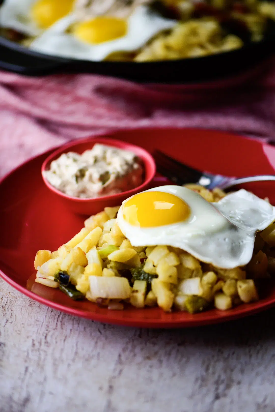 Serving of Vegetable Breakfast Skillet with side of poblano cream sauce