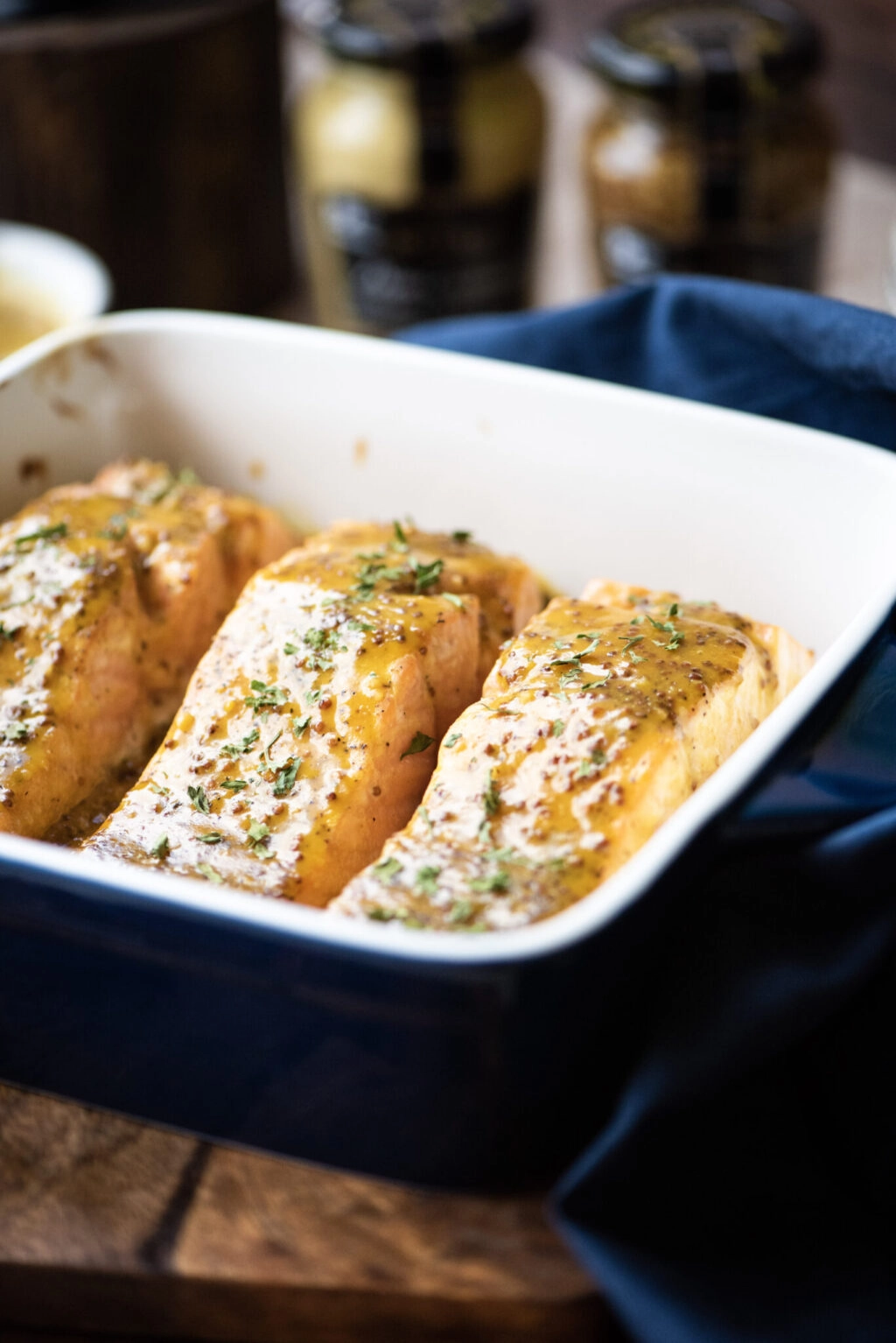 Close up of Honey-mustard glazed salmon is baking dish
