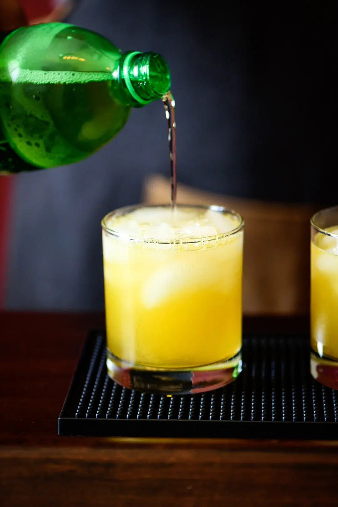 pouring soda or sparkling water for Mandarin Orange Crush Cocktail