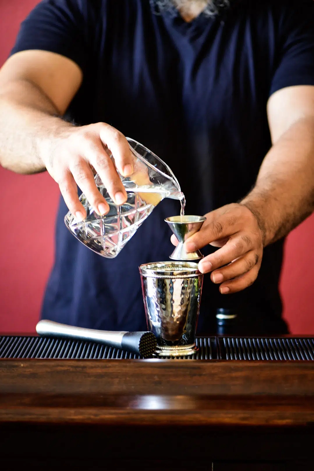 Pouring simple syrup into mint julep cup