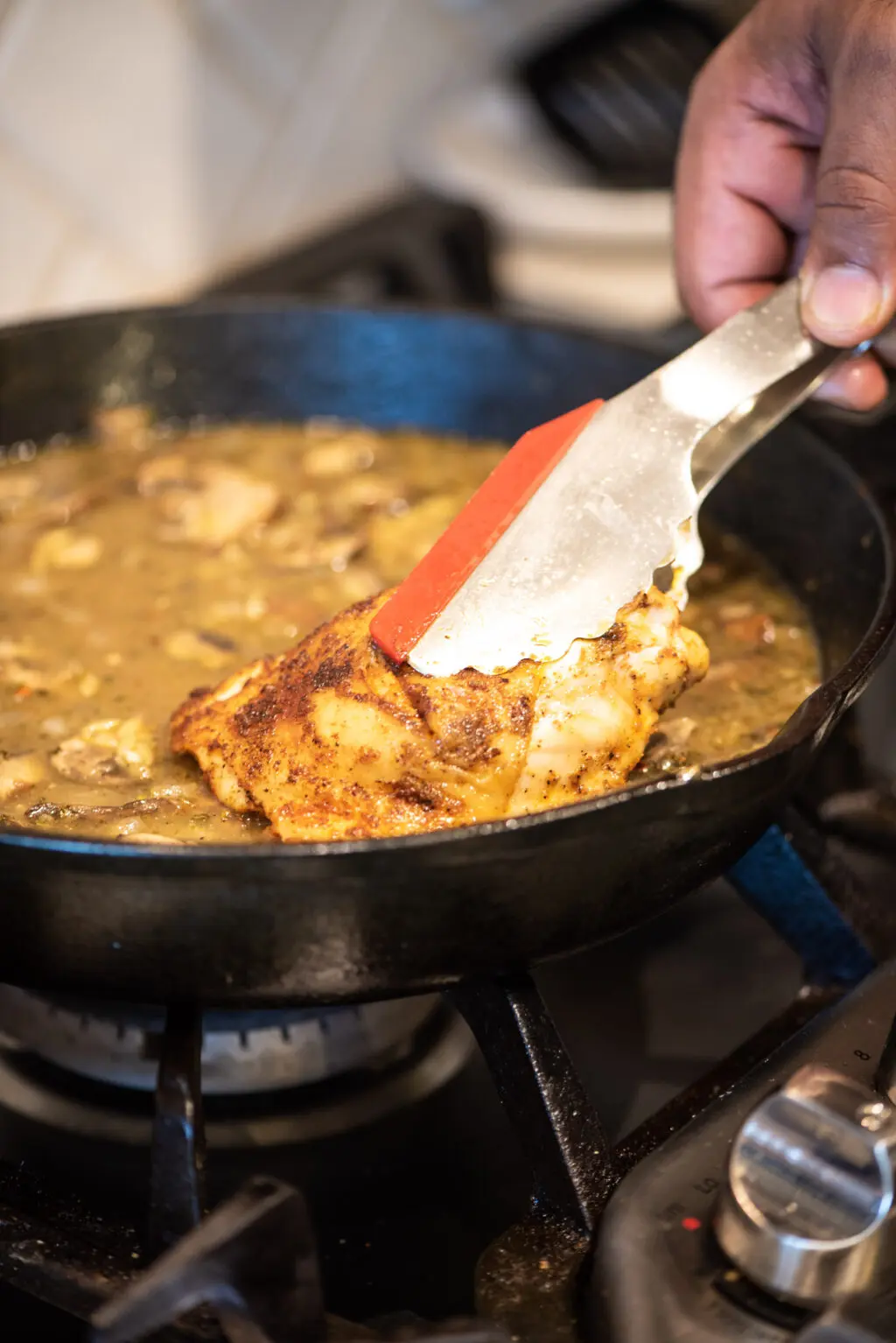 Adding chicken thighs back to pan with orzo