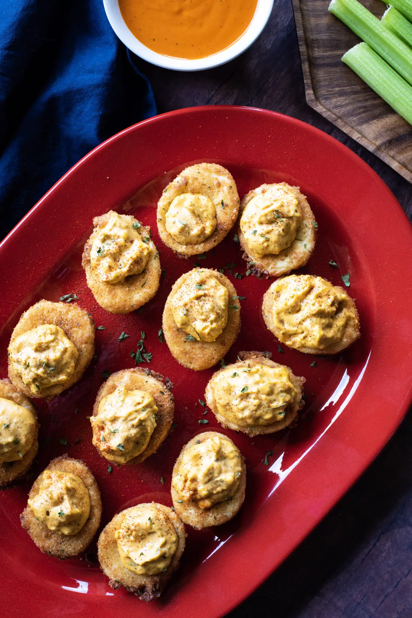 Overhead shot of full plate of buffalo fried deviled eggs