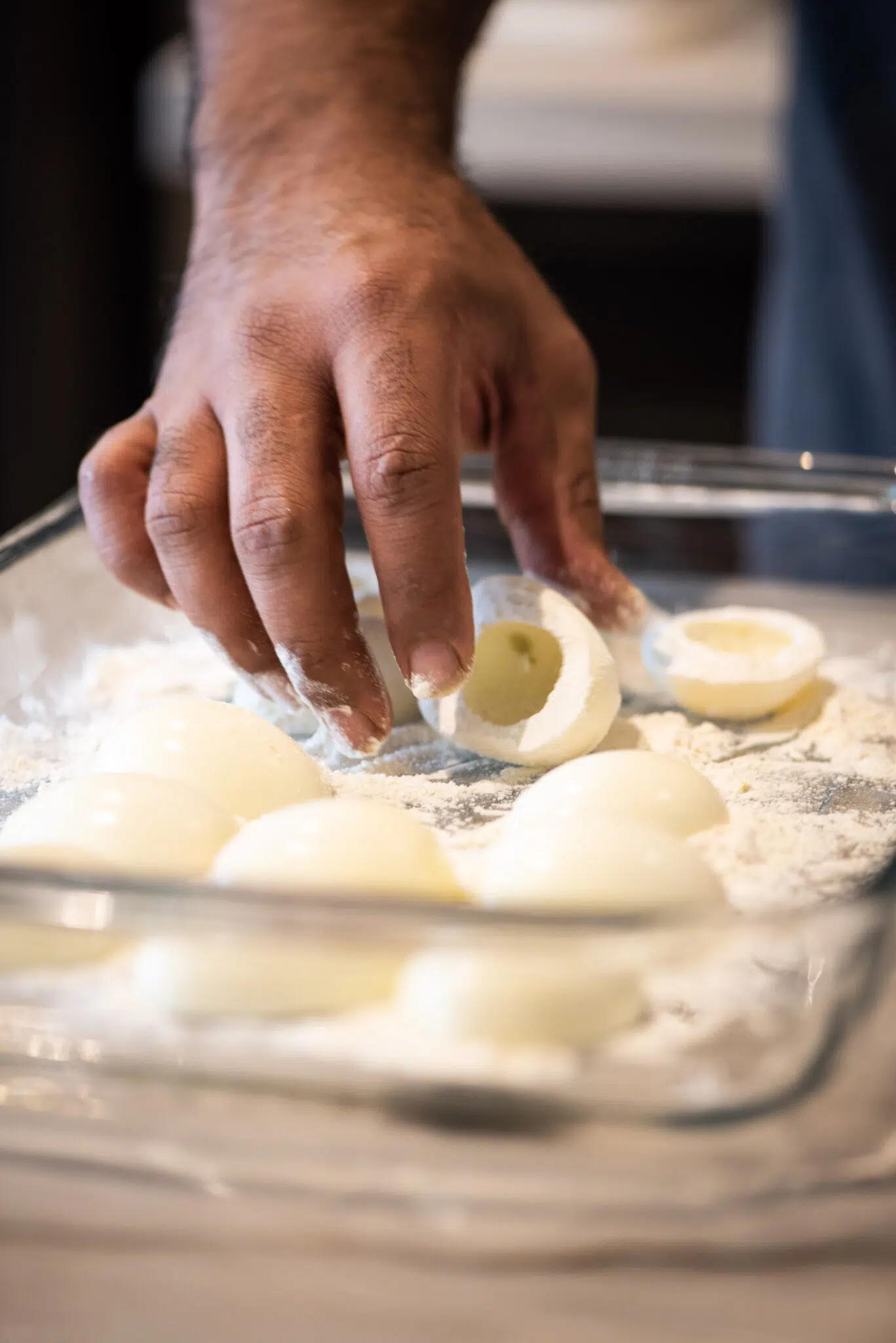 Flouring eggs to prepare to deep fry