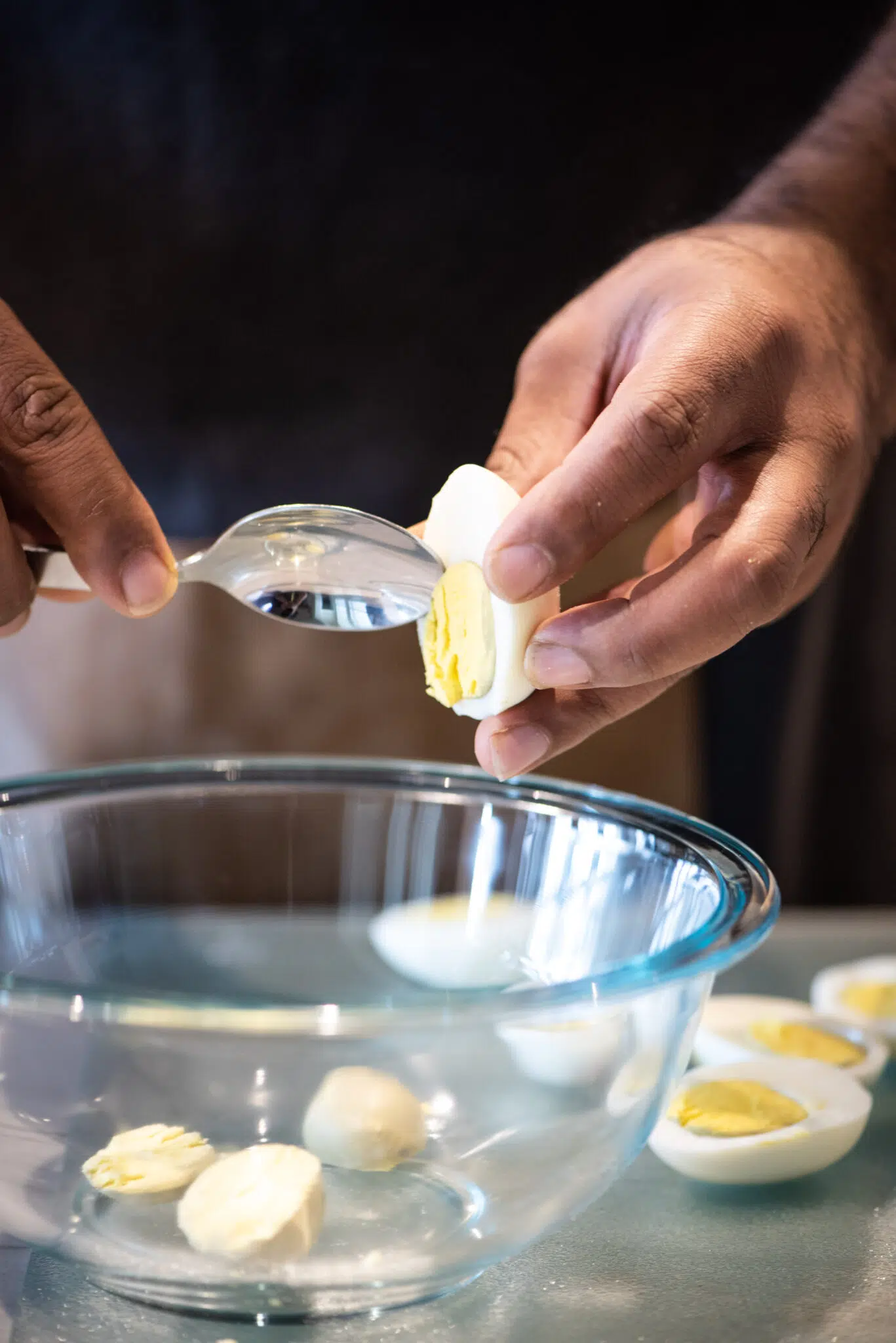 Removing yolk from hard boiled eggs