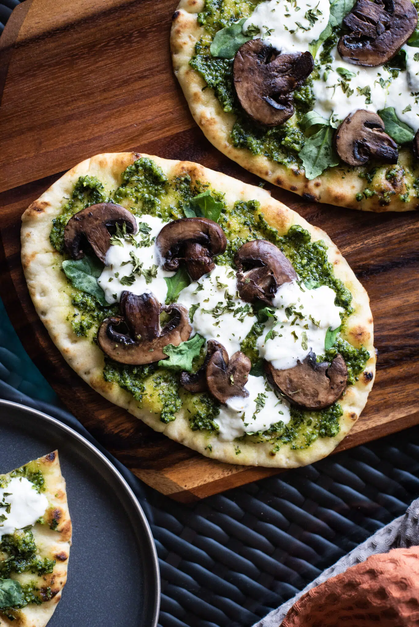 Overhead shot of two pesto mushroom flatbread pizza