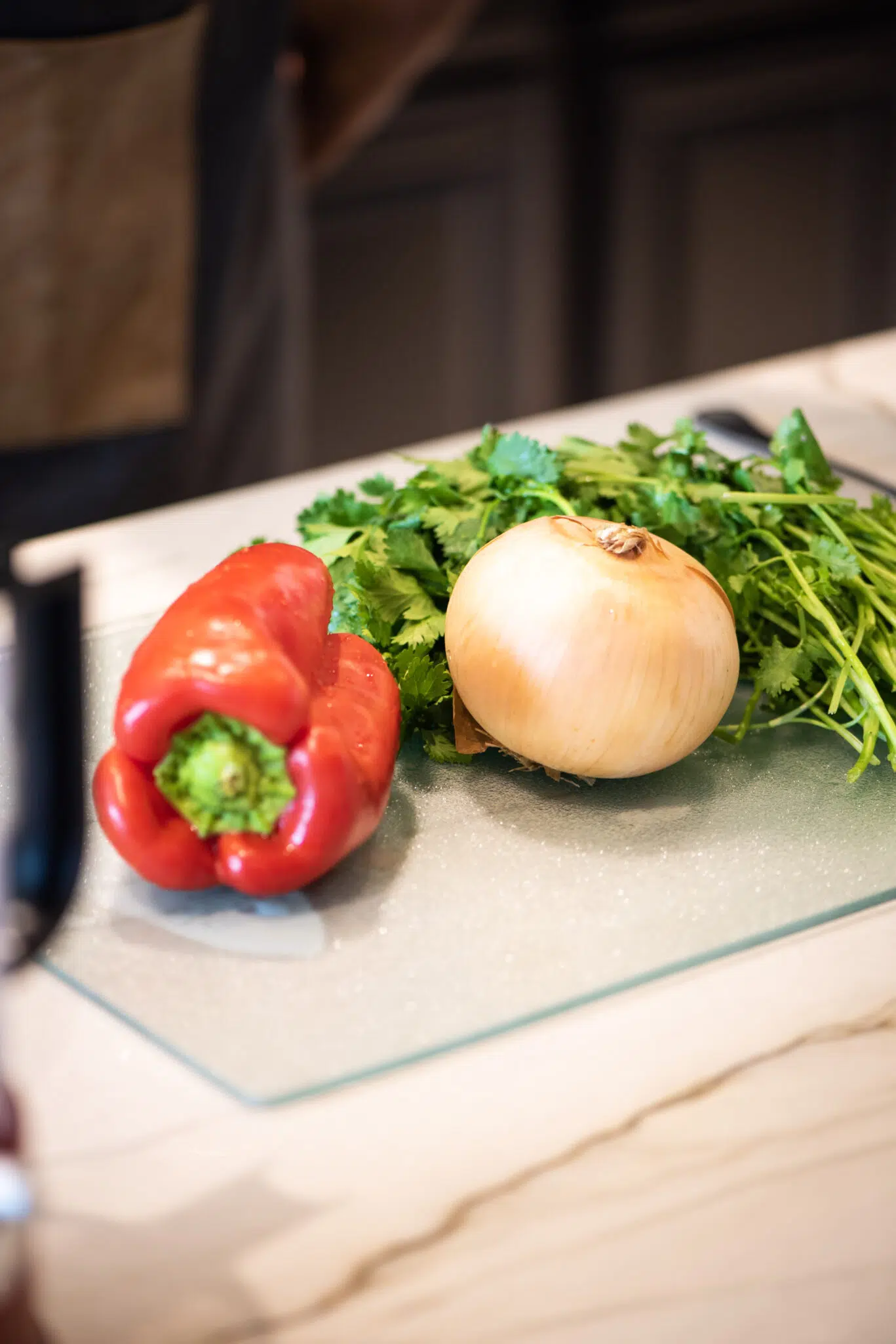 Fresh red bell peppers, yellow onion, and cilantro