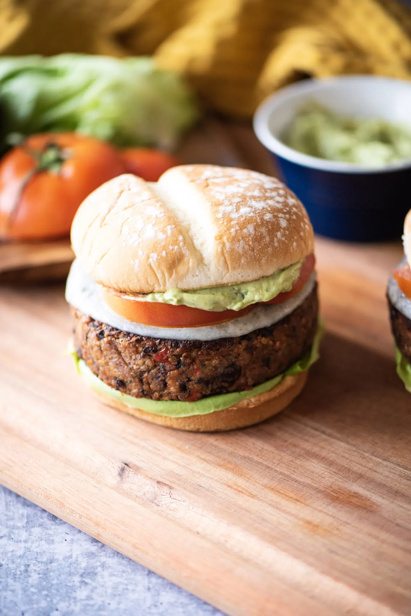 Black Bean burger with lettuce, tomato, and avocado cream sauce.