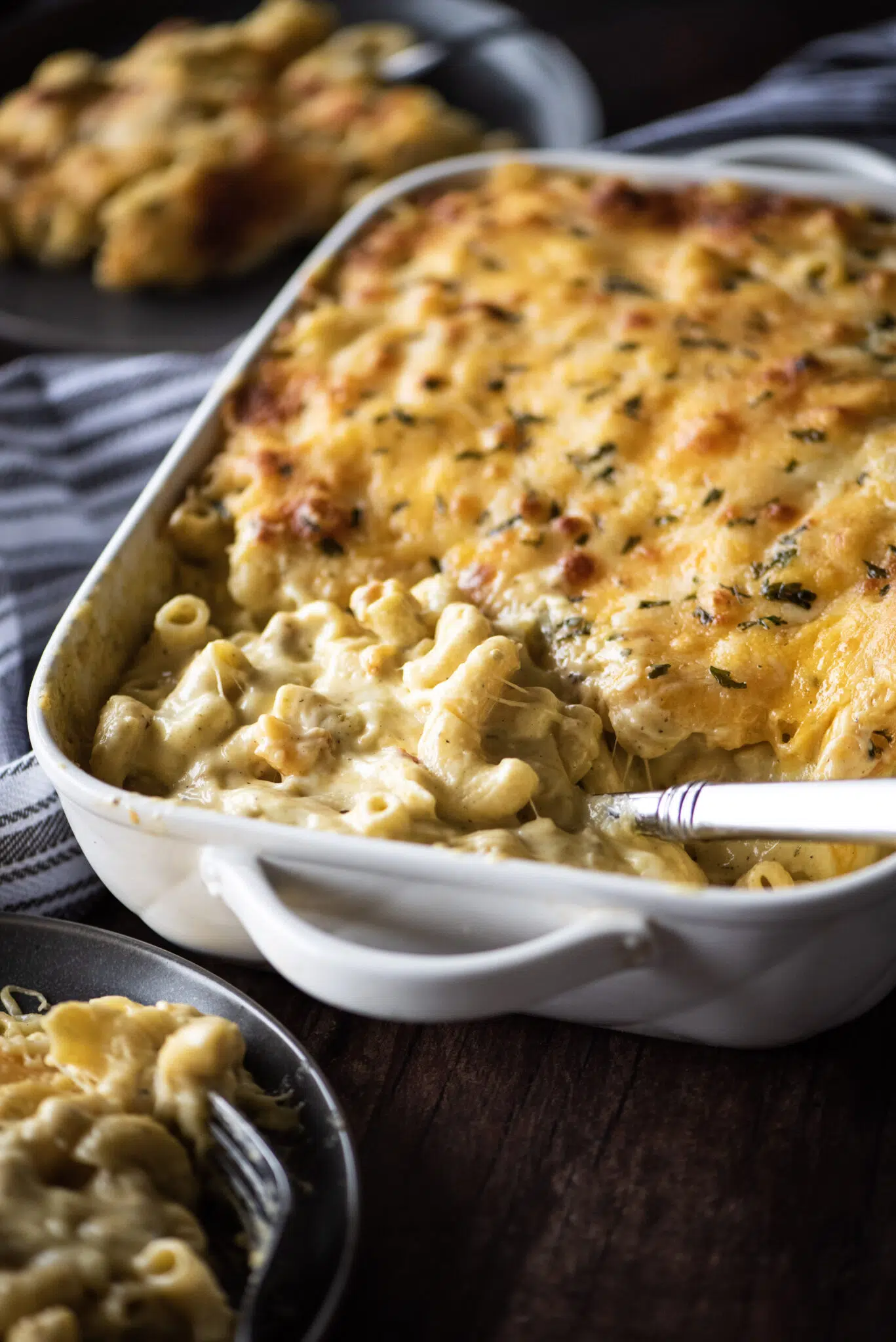 Baked macaroni and cheese being served from casserole